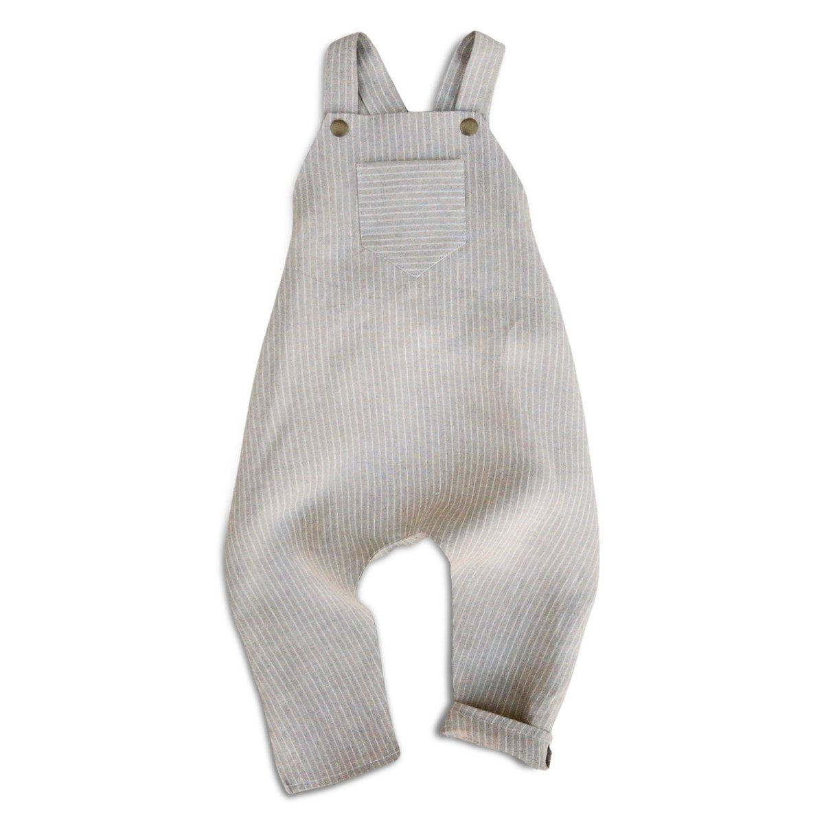 Photo of classic beige engineer stripe harem romper with pocket and brass snaps shown flat on a white background