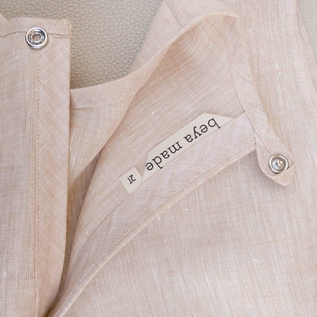 detail view of back opening and logo label of Beya Made pale pink linen baby box top